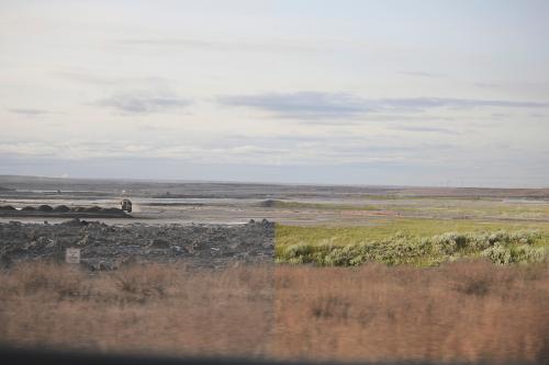 A Syncrude tailings pond edge as seen from Hwy 63’s Syncrude Loop. The industrial past of the site is seen on the left and an implemented phyto-remediation ecology is seen on the right